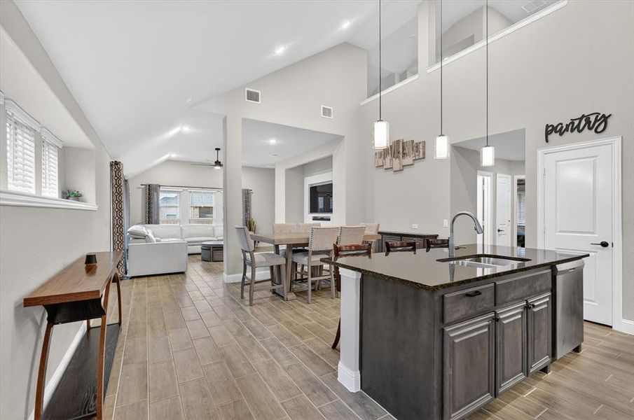 Spacious kitchen island with a dark countertop and undermount sink Spacious kitchen island with a dark countertop and undermount sink