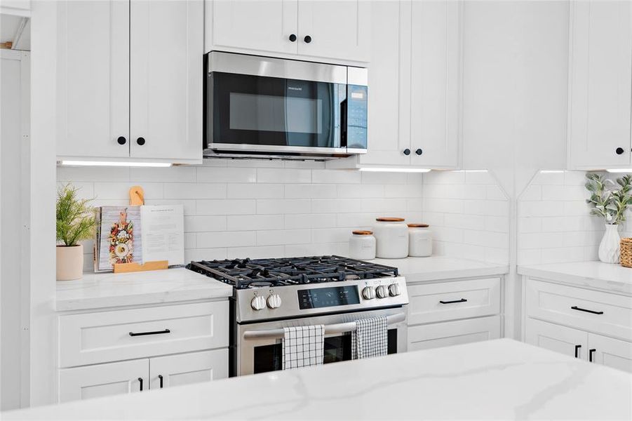 Enhancing the kitchen's timeless appeal is a classic subway backsplash, complemented by undermount cabinet lighting—a standard upgrade to this home, ensuring both style and functionality are seamlessly integrated.