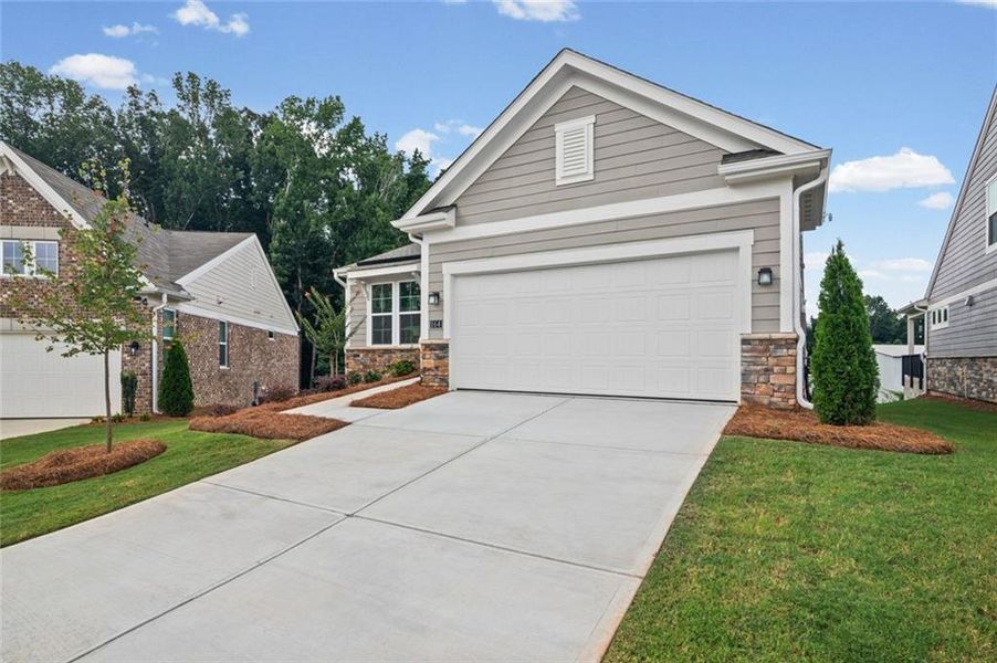 Front exterior of a new home in Laurel Farms, Dallas, GA, highlighting curb appeal (Image 1). Front exterior of a new home in Laurel Farms, Dallas, GA, highlighting curb appeal (Image 1).