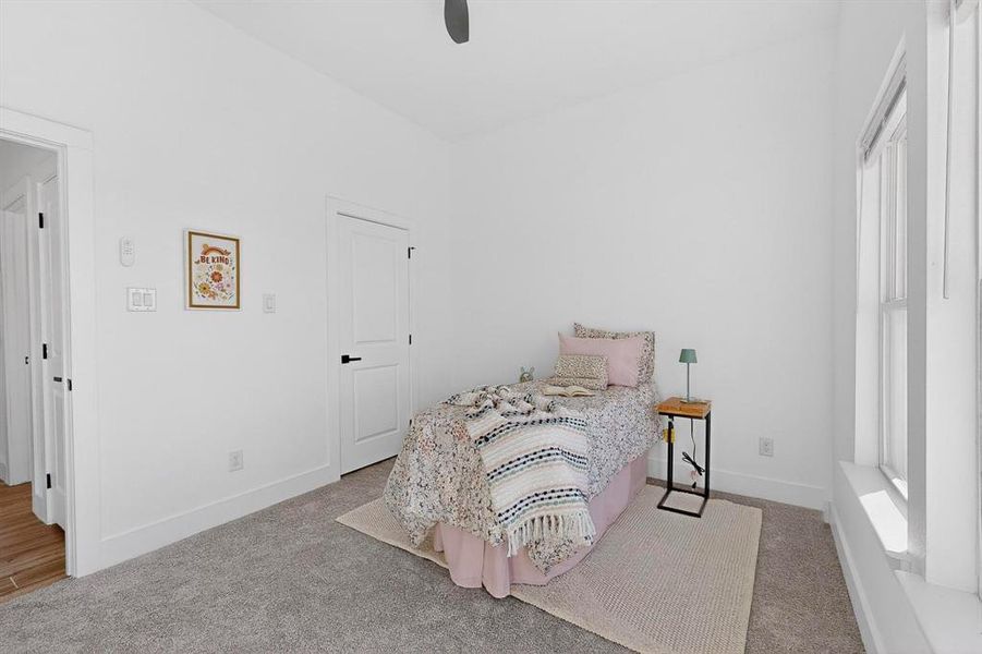 Bedroom featuring light carpet and ceiling fan
