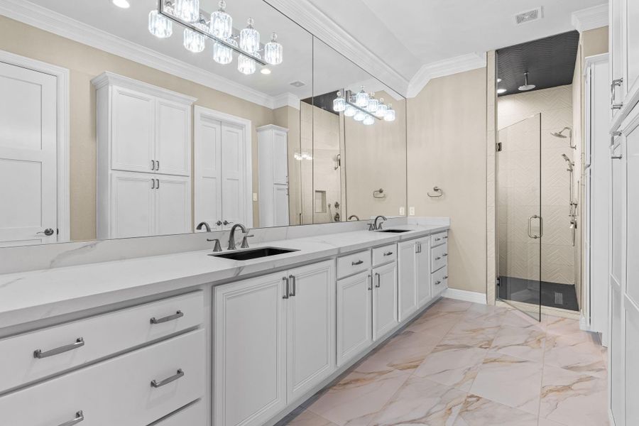 Sophisticated ensuite boasting dual vanities, quartz surfaces, and a spacious walk-in shower for a true retreat experience.