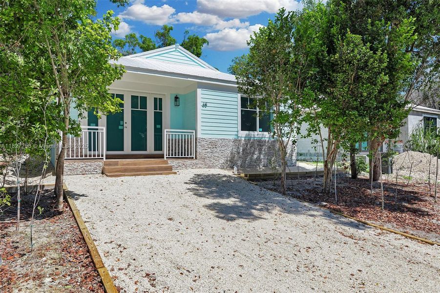 Front exterior of a new home in , Key Largo, FL, highlighting curb appeal (Image 1).