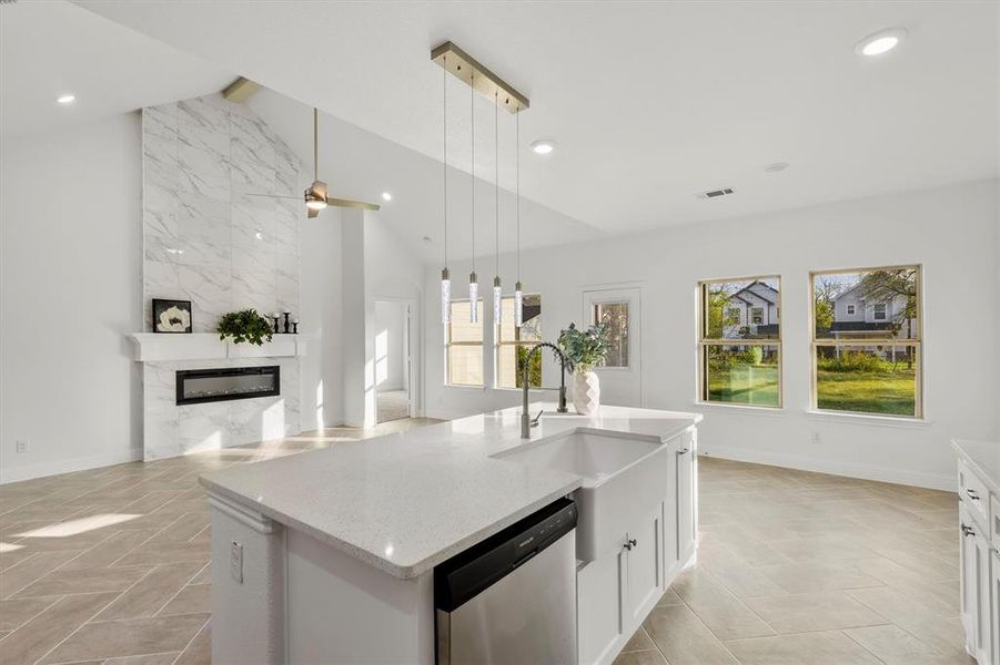 Kitchen featuring white cabinets, lofted ceiling, dishwasher, and a healthy amount of sunlight