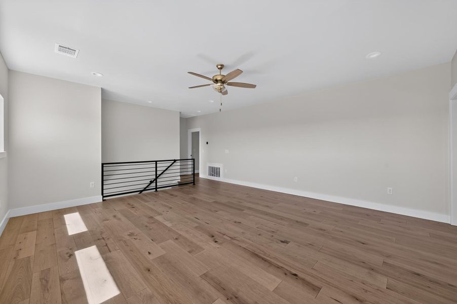 Warm wood flooring and clean lines define this versatile upper-level living space.