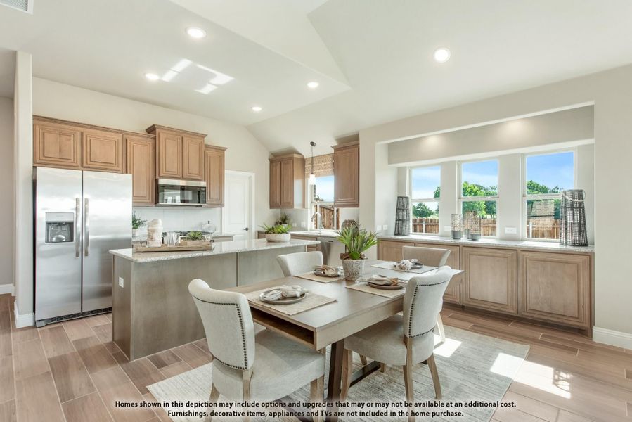 Open kitchen and dining area with wood cabinets, granite island, stainless appliances, and dining table for four near large windows