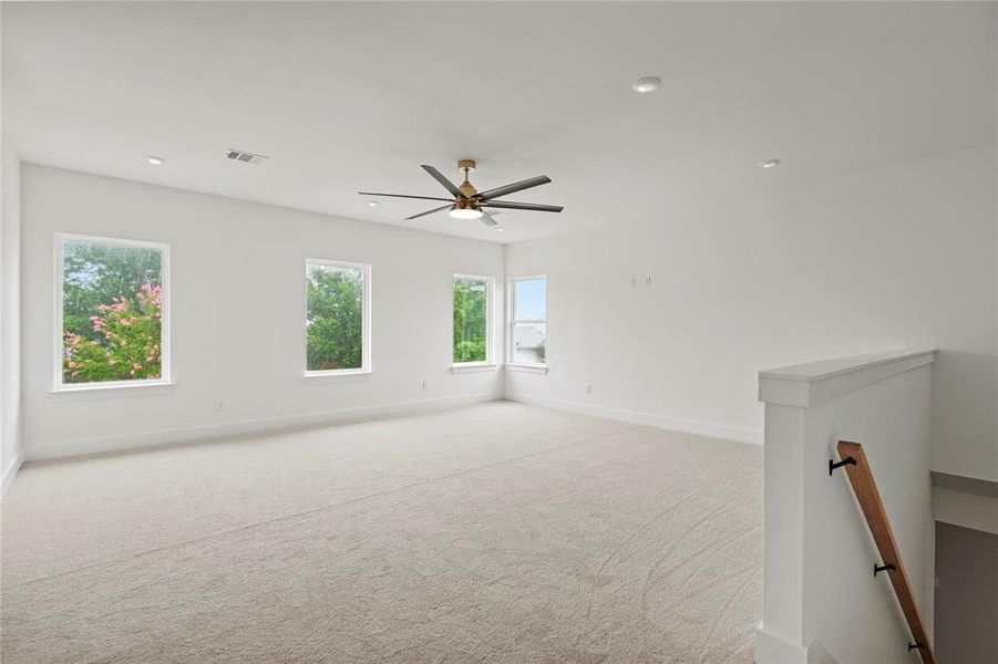 Spare room with light carpet, recessed lighting, and a ceiling fan Spare room with light carpet, recessed lighting, and a ceiling fan