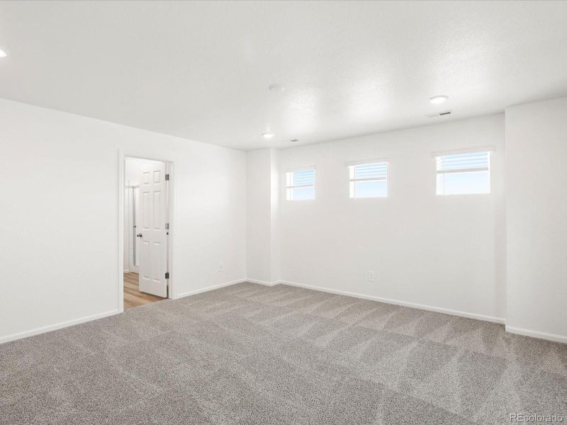 Spacious, unfurnished interior of a new home in Ridgeline Vista: The Flora Collection, Brighton (Image 23).