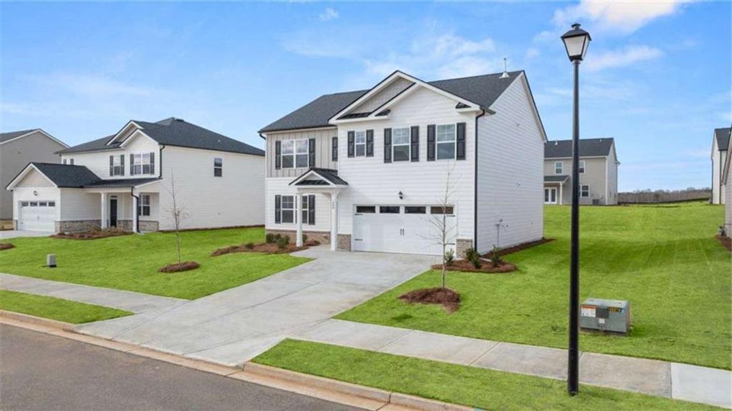 Front exterior of a new home in Preserve at Dove Creek, Statham, GA, highlighting curb appeal (Image 25). Front exterior of a new home in Preserve at Dove Creek, Statham, GA, highlighting curb appeal (Image 25).