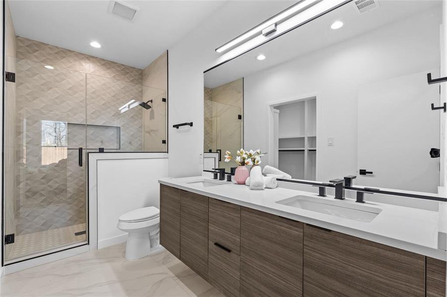 Bathroom featuring a spacious closet, a stall shower, double vanity, recessed lighting, and light marble finish floors Bathroom featuring a spacious closet, a stall shower, double vanity, recessed lighting, and light marble finish floors