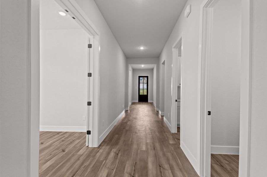 A hallway with white doors.
