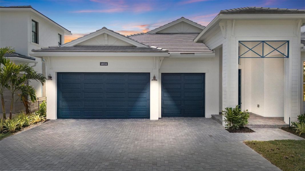 Front exterior of a new home in Esprit at Avenir, Palm Beach Gardens, FL, highlighting curb appeal (Image 24).