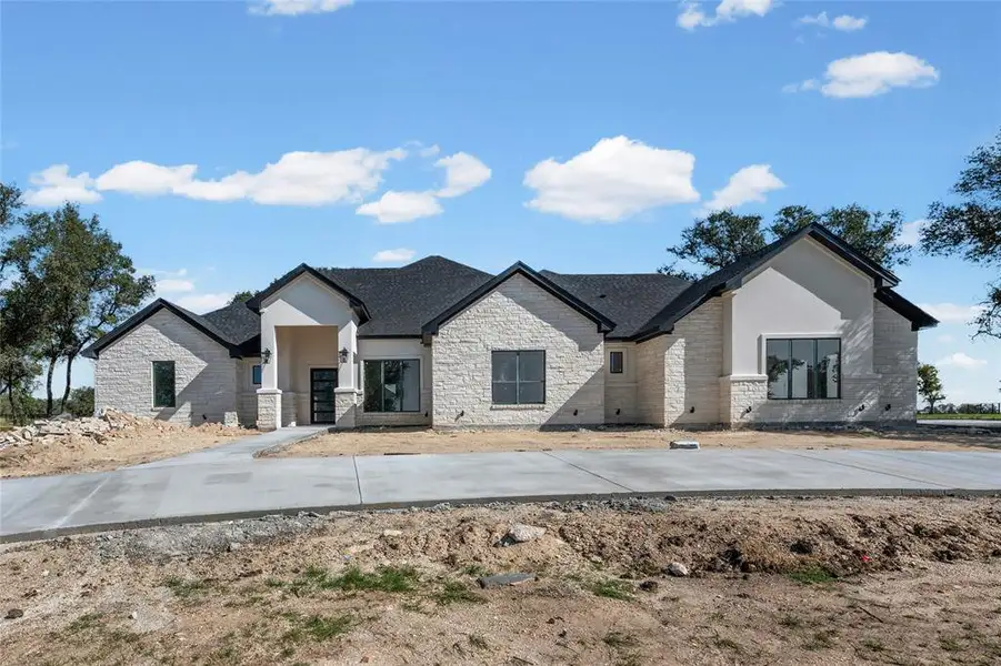 Front exterior of a new home in , Temple, TX, highlighting curb appeal (Image 1).