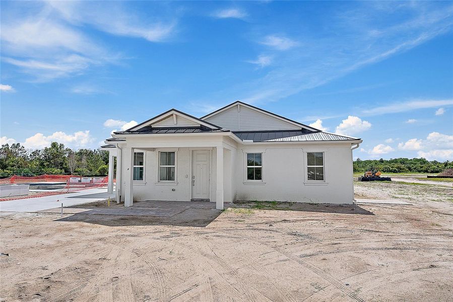 Front exterior of a new home in Bridgewater, Jupiter, FL, highlighting curb appeal (Image 26). Front exterior of a new home in Bridgewater, Jupiter, FL, highlighting curb appeal (Image 26).