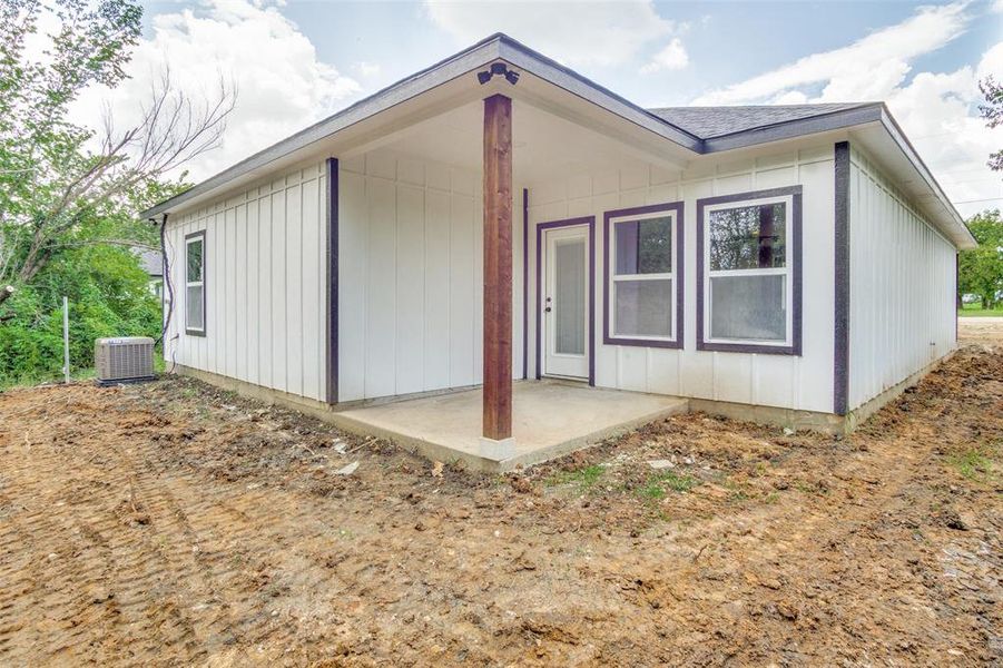 Rear view of house featuring a patio area and central AC unit