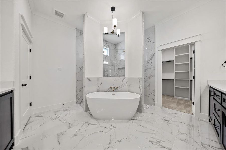 Bathroom with vanity, a chandelier, marble finish floors, a soaking tub, and a marble finish shower Bathroom with vanity, a chandelier, marble finish floors, a soaking tub, and a marble finish shower