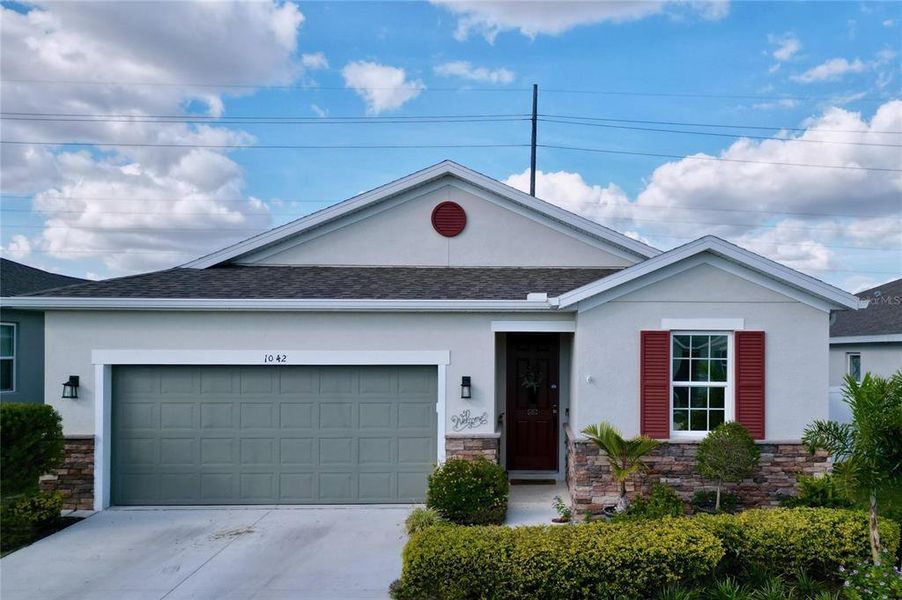 Front exterior of a new home in Seasons at Heritage Square, Haines City, FL, highlighting curb appeal (Image 19). Front exterior of a new home in Seasons at Heritage Square, Haines City, FL, highlighting curb appeal (Image 19).