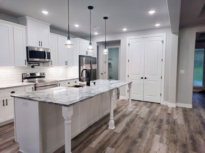 Stainless appliances and French door pantry.