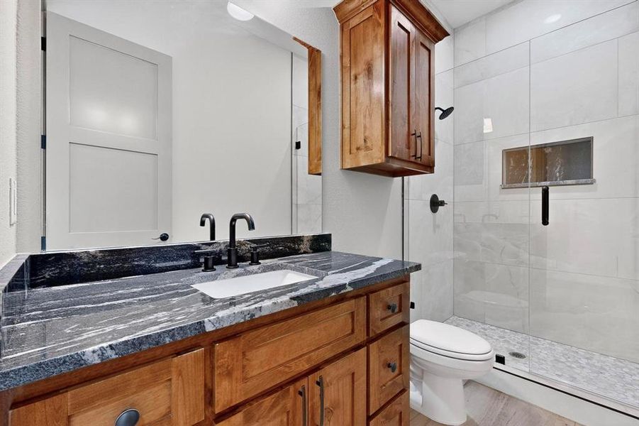 Bathroom with vanity and a shower stall Bathroom with vanity and a shower stall