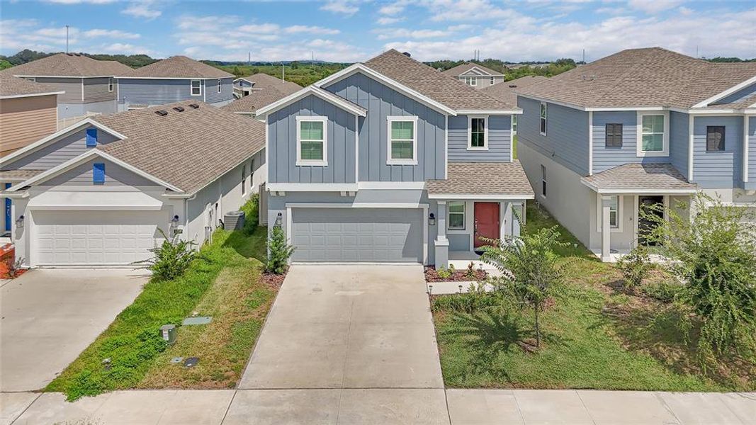 Front exterior of a new home in Peace Creek Reserve, Winter Haven, FL, highlighting curb appeal (Image 21).