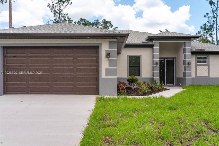 Front exterior of a new home in , Lehigh Acres, FL, highlighting curb appeal (Image 16).