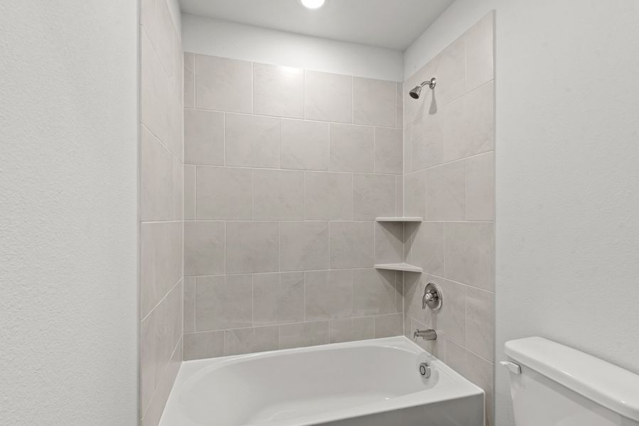 A bathroom with a bathtub and toilet. A bathroom with a bathtub and toilet.