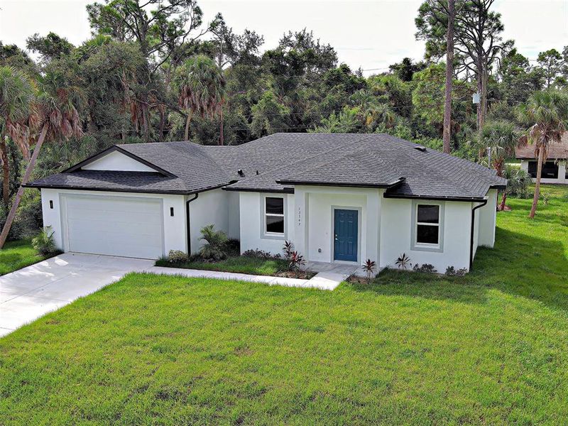Front exterior of a new home in , Port Charlotte, FL, highlighting curb appeal (Image 23).