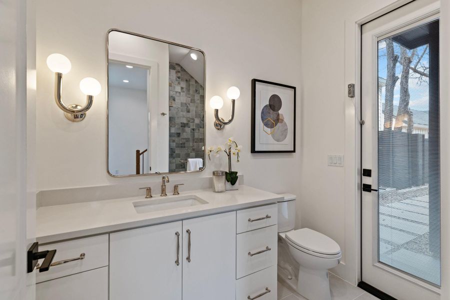 Full bath featuring toilet, vanity, and tile patterned flooring