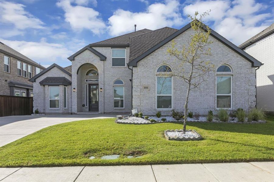 French country home with a front yard