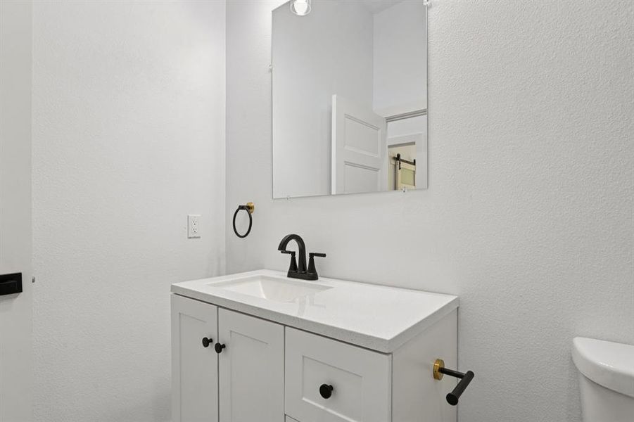 Bathroom with a textured wall and vanity Bathroom with a textured wall and vanity