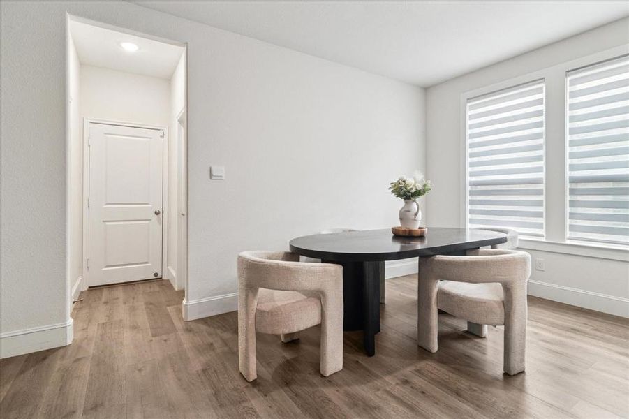 Dining area featuring light wood-type flooring and baseboards Dining area featuring light wood-type flooring and baseboards