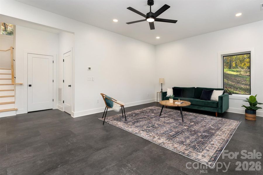 Flex/bonus room looking back to stairs and door to utility room and a large storage closet