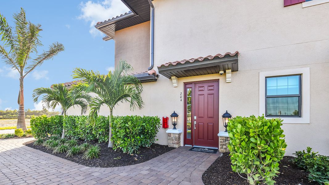 Front exterior of a new home in Esplanade by the Islands Coach Homes, Naples, FL, highlighting curb appeal (Image 19).