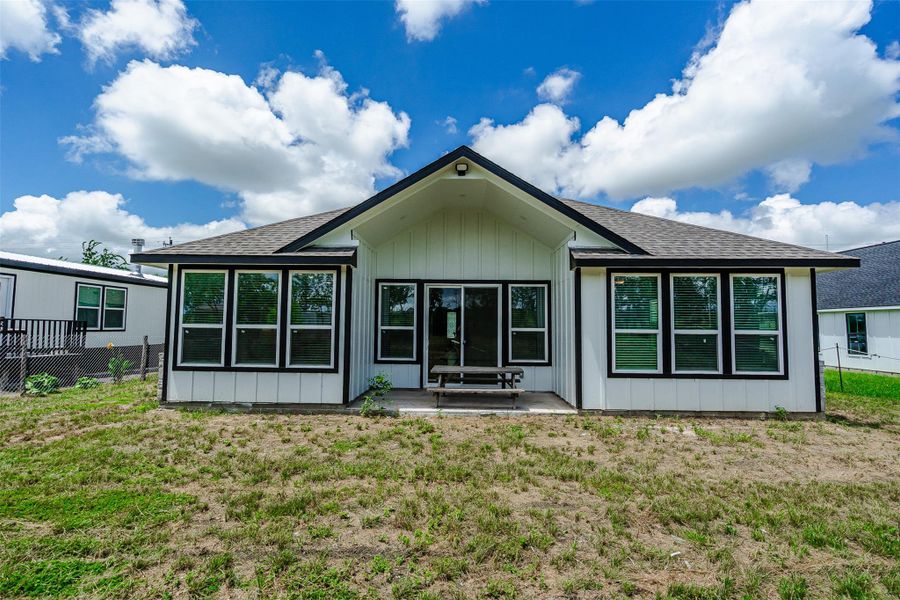 A well-maintained facade with large windows and a small concrete patio awaits your personal touch. A well-maintained facade with large windows and a small concrete patio awaits your personal touch.
