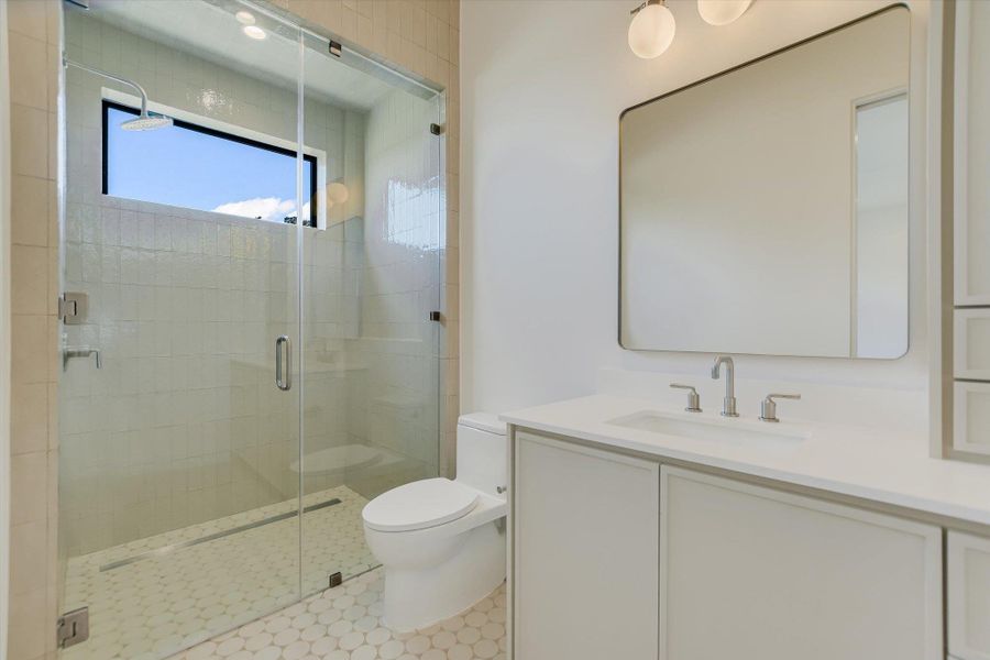 Full bath with vanity and a shower stall