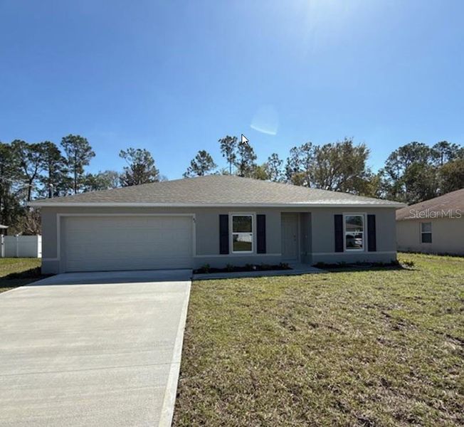Front exterior of a new home in Palm Coast: Value Collection, Palm Coast, FL, highlighting curb appeal (Image 2).