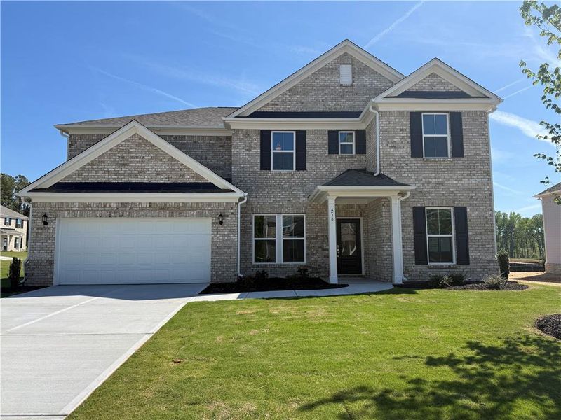 Front exterior of a new home in Anderson Point Estates, McDonough, GA, highlighting curb appeal (Image 2). Front exterior of a new home in Anderson Point Estates, McDonough, GA, highlighting curb appeal (Image 2).