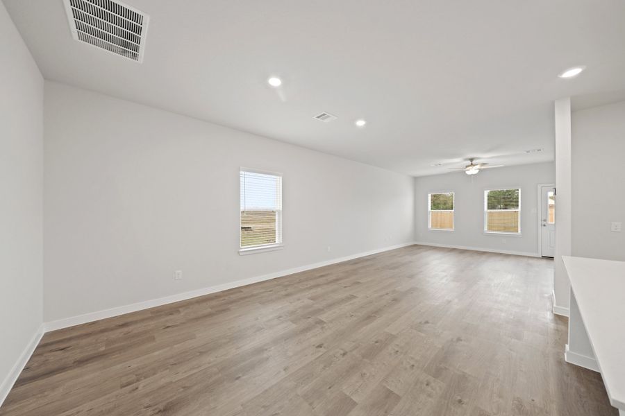 A room with a wood floor and white walls. A room with a wood floor and white walls.