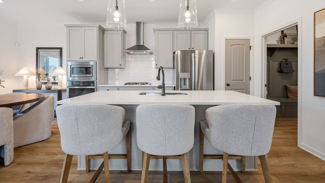 Kitchen with pendant lighting, tile backsplash, and quartz countertops Kitchen with pendant lighting, tile backsplash, and quartz countertops