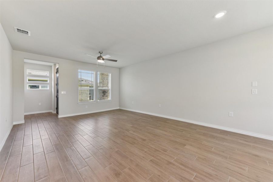 Unfurnished room featuring light wood finished floors and a ceiling fan Unfurnished room featuring light wood finished floors and a ceiling fan