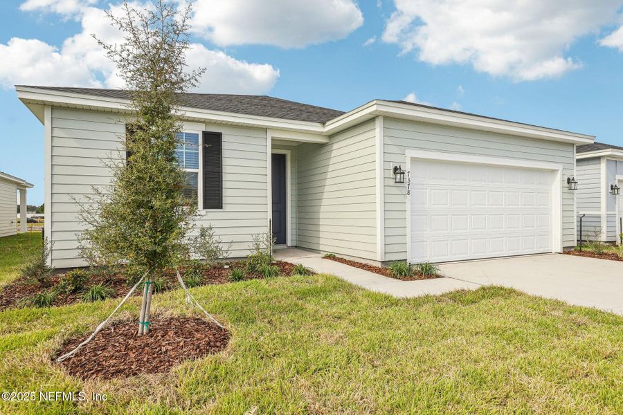 Front exterior of a new home in Cypress Meadows - Signature Series, Jacksonville, FL, highlighting curb appeal (Image 19).
