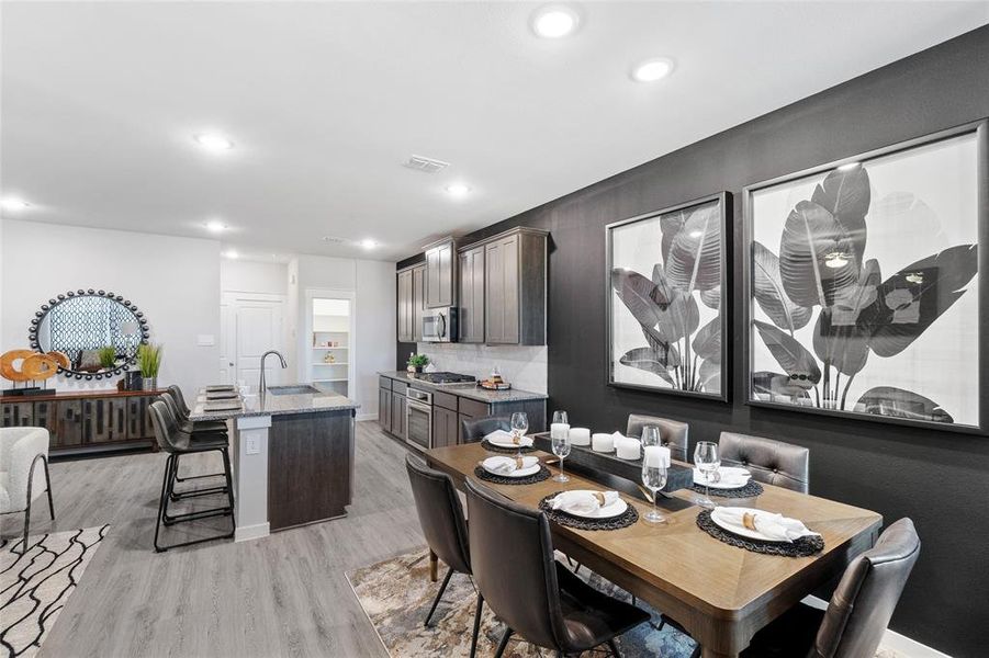 Dining room with sink and light hardwood / wood-style floors