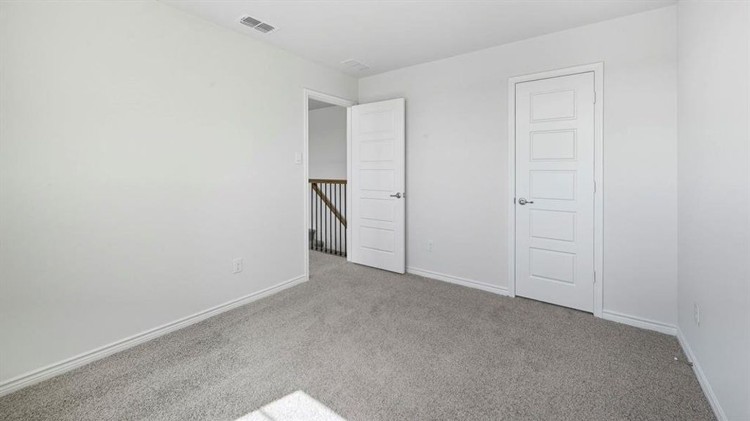 Unfurnished bedroom with carpet and baseboards
