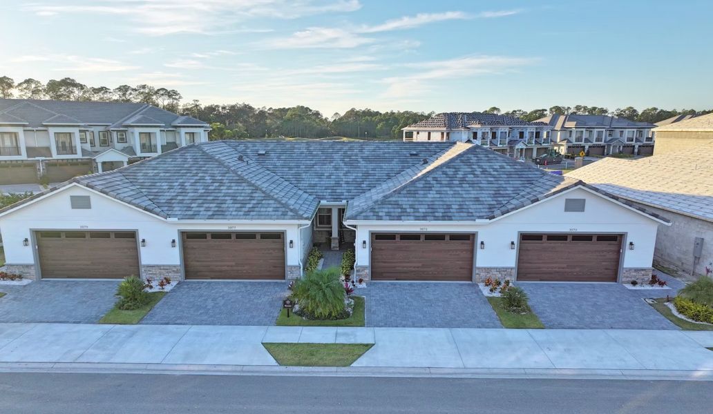 Representative exterior photo of a completed home built from the The Abaco by Johnson Group Homes in Isles at Venetian Bay/TH, New Smyrna Beach, FL (Image 4). Representative exterior photo of a completed home built from the The Abaco by Johnson Group Homes in Isles at Venetian Bay/TH, New Smyrna Beach, FL (Image 4).
