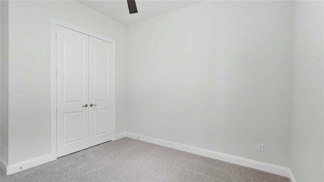Light gray wall paint complements the gray carpeting