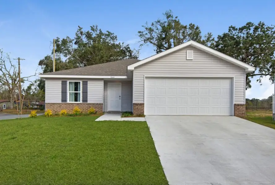 Front exterior of a new home in Mahogany At Jubilee, Pace, FL, highlighting curb appeal (Image 2). Front exterior of a new home in Mahogany At Jubilee, Pace, FL, highlighting curb appeal (Image 2).