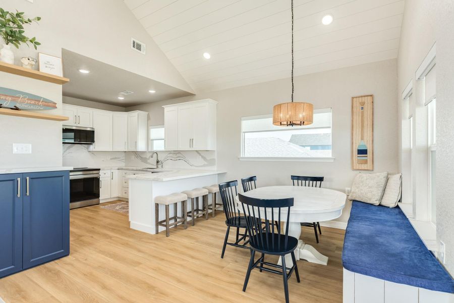 Open dining area includes a built-in window bench and flows seamlessly into the kitchen, making everyday meals and entertaining effortless.