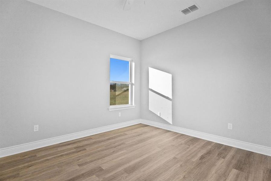 Unfurnished room featuring light wood-style floors and baseboards