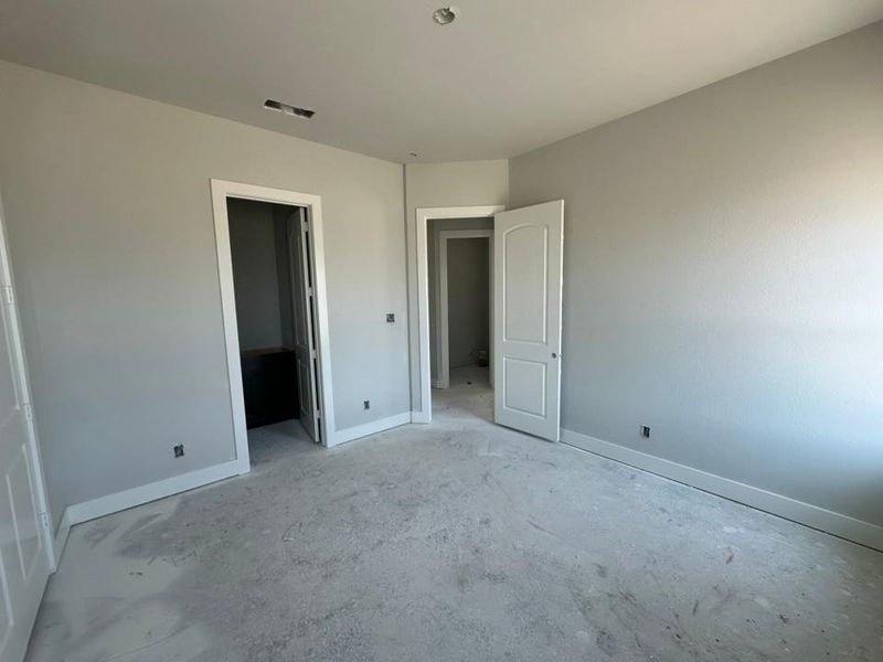 Interior room featuring light gray painted walls with white baseboards and trim