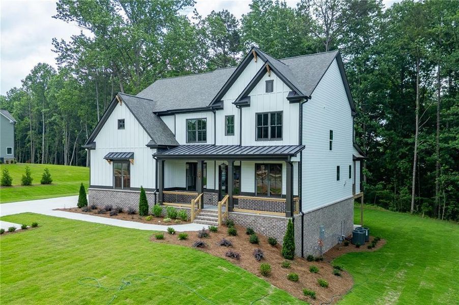Front exterior of a new home in , Cumming, GA, highlighting curb appeal (Image 2). Front exterior of a new home in , Cumming, GA, highlighting curb appeal (Image 2).