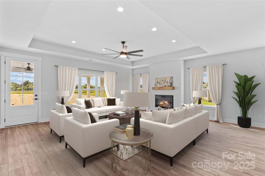 Den has 10 ft tray ceiling & shiplap wall fireplace.